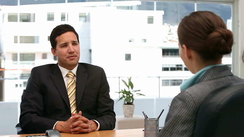 Interview between a businessman and a woman in his office