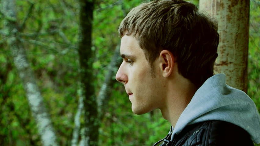 Photographing forests. A young man with a camera photographing beautiful green scenery.