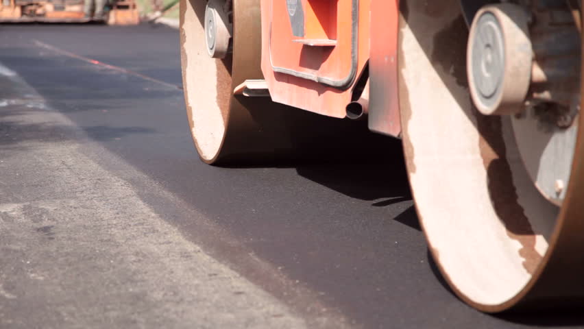 Steamroller compressing asphalt