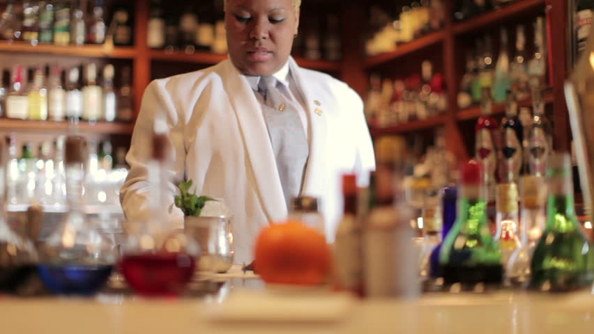 A series of model released clips featuring a female cocktail waiter in a classic looking cocktail bar in barcelona, Spain