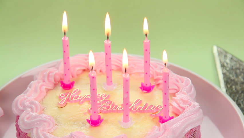 A beautiful cake with light candles to blow out wishing you a Happy Birthday. 