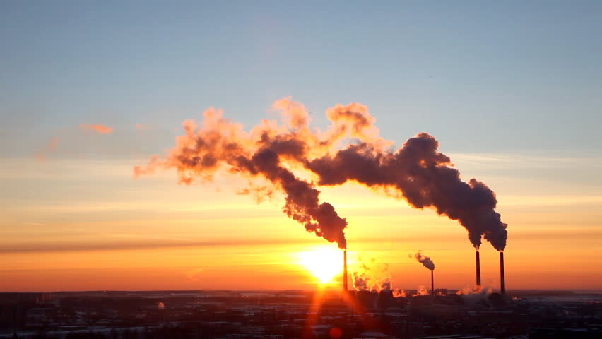 Thermal power station smoke silhouette at sunset