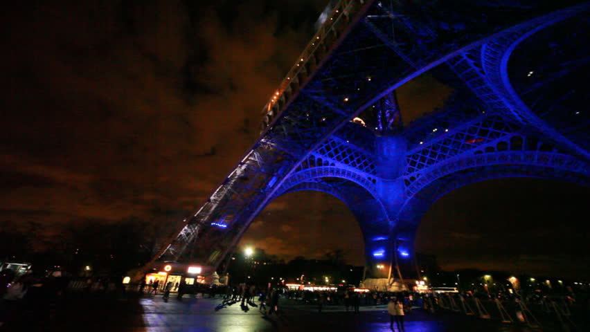 PARIS - DECEMBER 29: Eiffel Tower illuminated at night on background of cloudy sky, panorama from bottom up, December 29, 2009, Paris, France. The Eiffel Tower is the world's most visited paid monument.