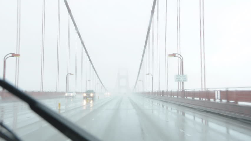 Drive lapse over the Golden Gate Bridge on a rainy foggy day
