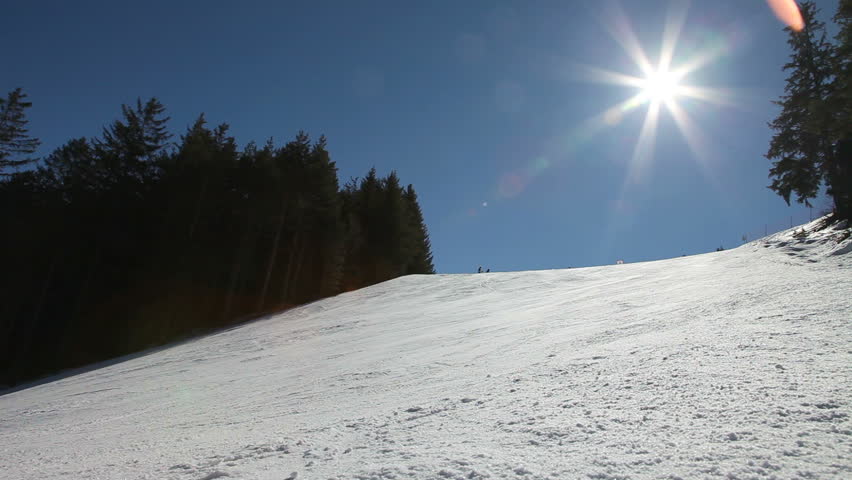 Ski slope with skiers and snowboarders 