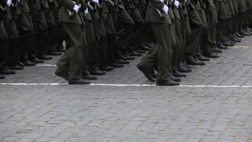 legs soldiers march in rows on pavement at military parade