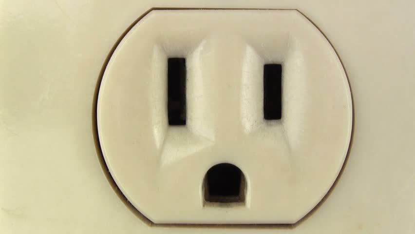 Plug in electronic into outlet macro closeup