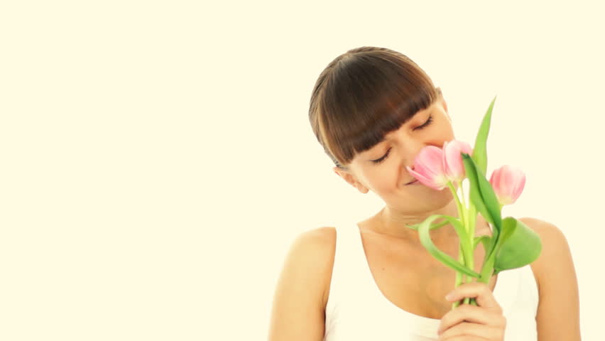 Young romantic woman smell spring tulips, isolated