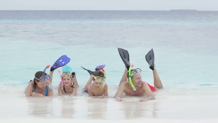 family with kids and snorkeling gear  