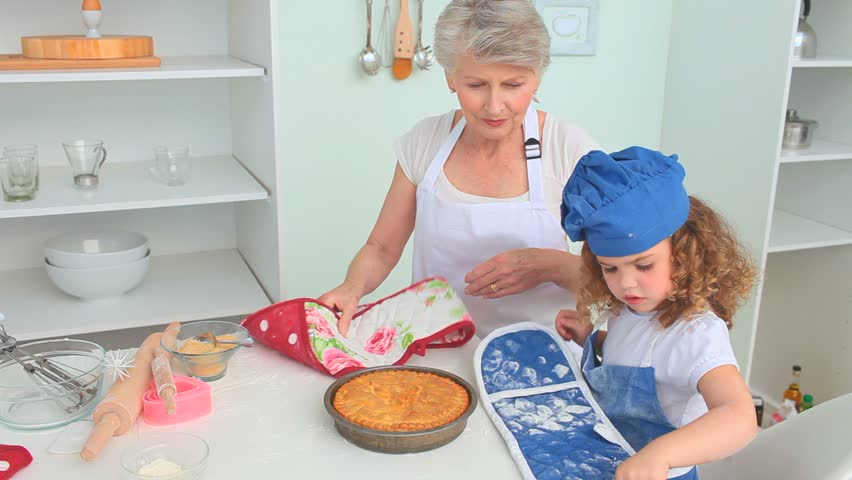Cute little girl cooking with her grandmother