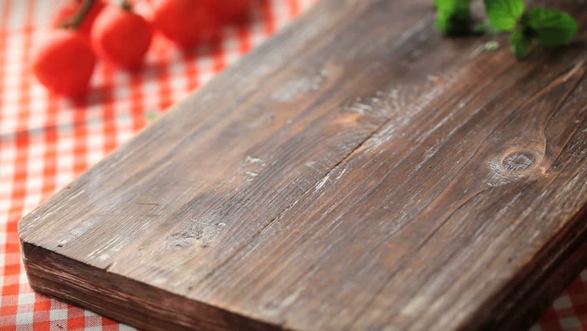 placing fresh cooked pizza on cutting  board