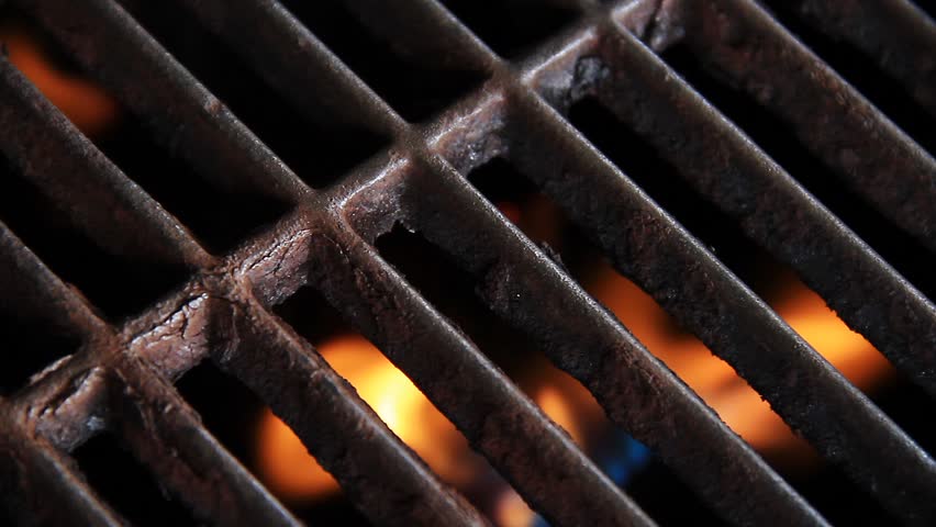 Grill with gas flames beneath. 