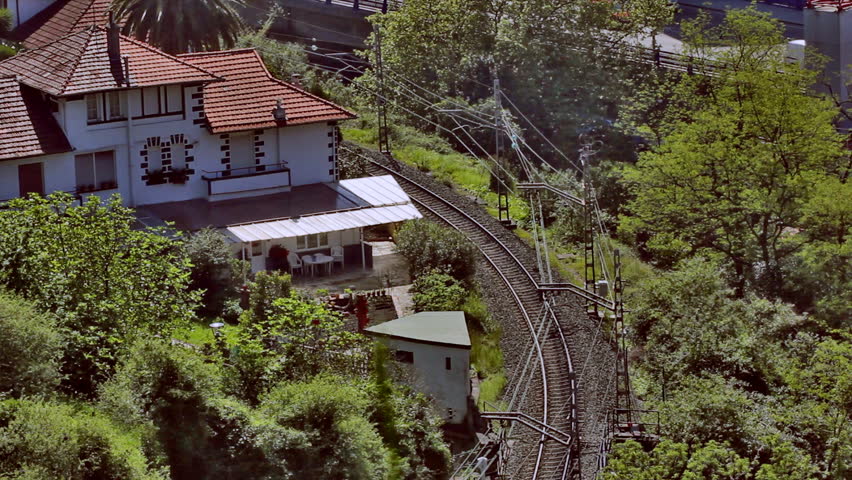 Train near building. HD 1920x1080x29.97. Format: Photo-JPEG. Duration: 00:00:20:00 (Realtime).
