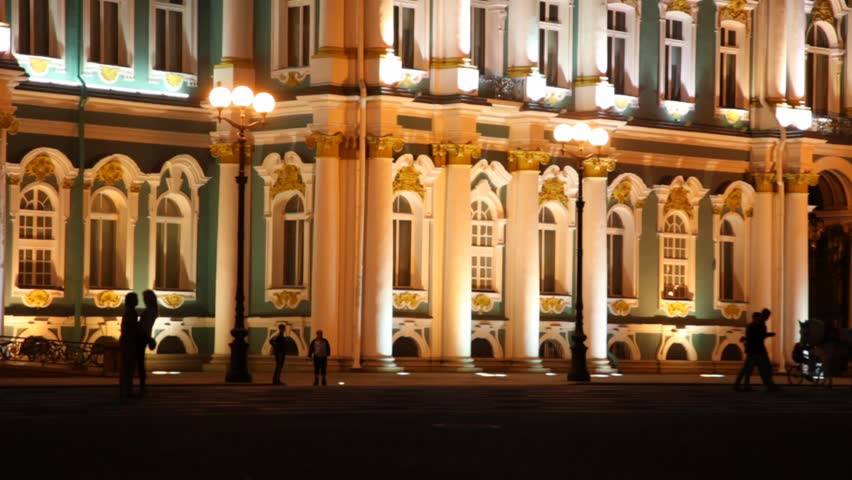 Horses harnessed go to carriage on Palace Square in front of facade Hermitage evening