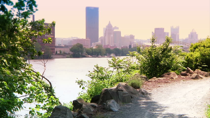 A young couple bike and sightsee on the bike trails on Washington's Landing, an island on the Allegheny River near Pittsburgh, Pennsylvania.