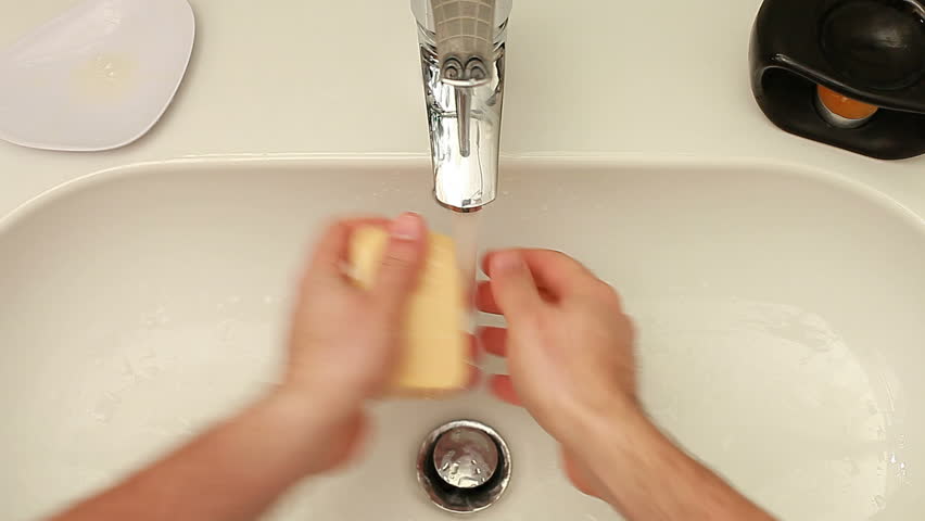 Washing hands in faucet
