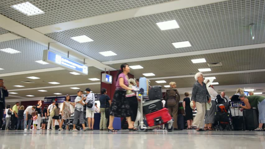 FIUMICINO, ITALY - JULY 16: People with bags boarding inside Leonardo da Vinci-Fiumicino Airport on July 16, 2010, Fiumicino, Italy. Fiumicino Airport is the largest airport in Italy, with 36.3 million passengers served in 2010. 