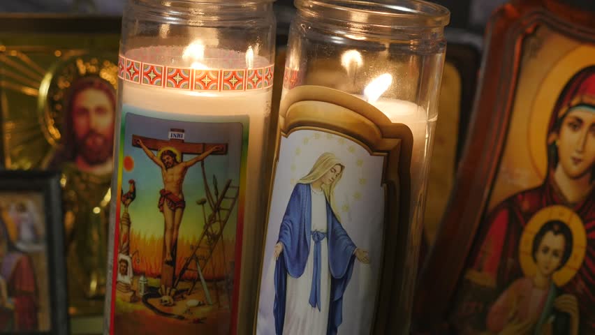 A Christian Icon Of Mother Mary Holding Jesus In Front Of A Candle