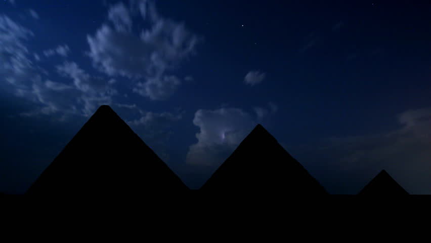 Egyptian pyramids waiting for the upcoming storm in the night