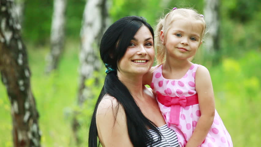 Daughter hugging and kissing mother 