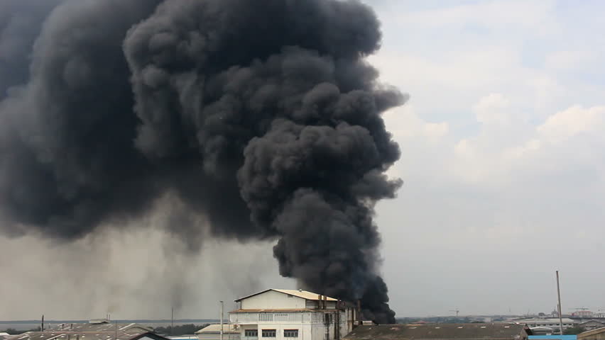 Massive Black Smoke From A Building Far Away Wide Shot Industrial