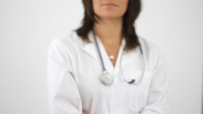 Female doctor offering green apple, isolated