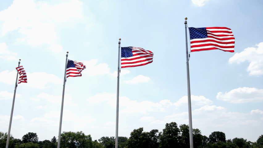 Four flags in a row blowing in wind