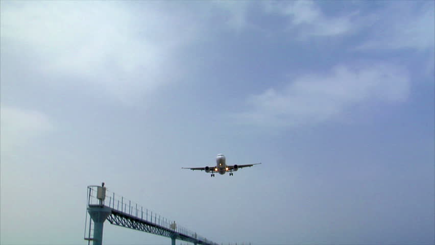 airplane landing over seaside