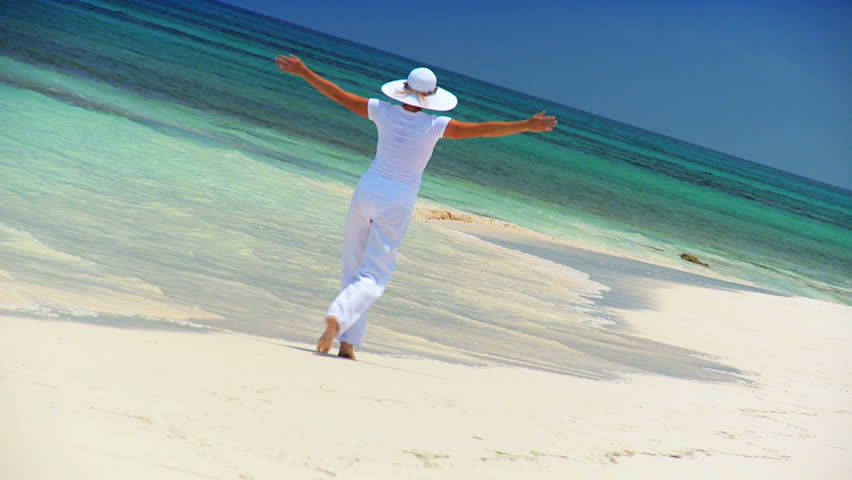 Elegant young female reveling in achieving her fantasy of a luxury island vacation