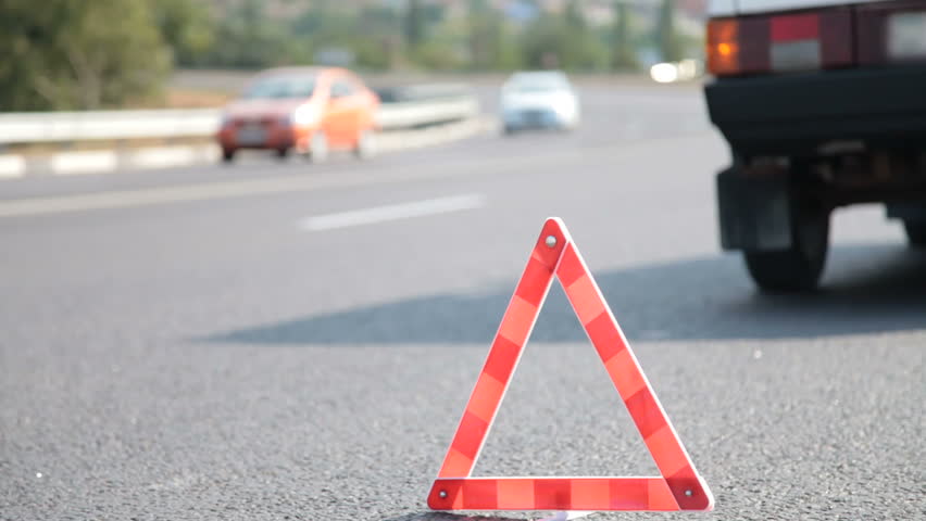 Red warning triangle with a broken down car