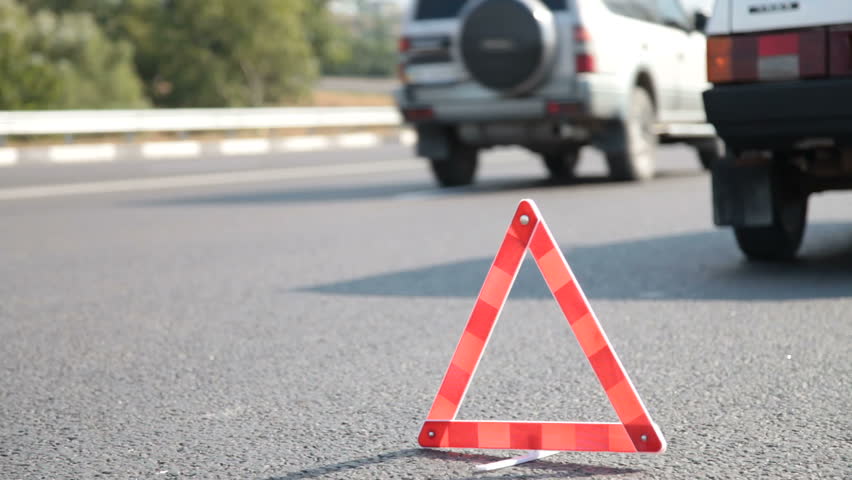Red warning triangle with a broken down car