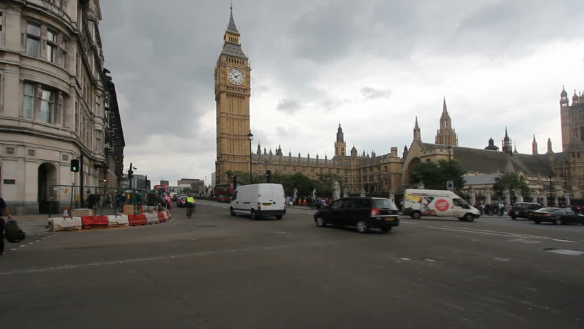 Public bus and other traffic drives past Big Ben in London