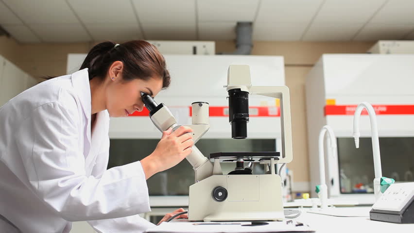 Young scientist working with a microscope in a laboratory