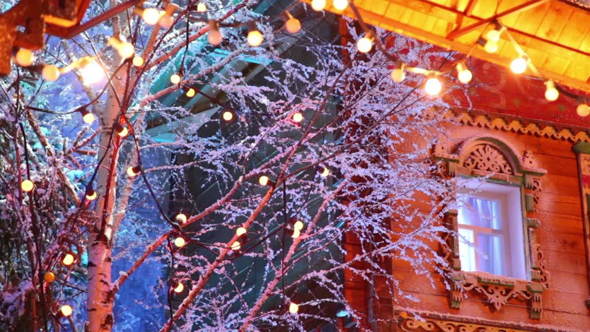 Garland on branches of artificial birch and under wooden roof
