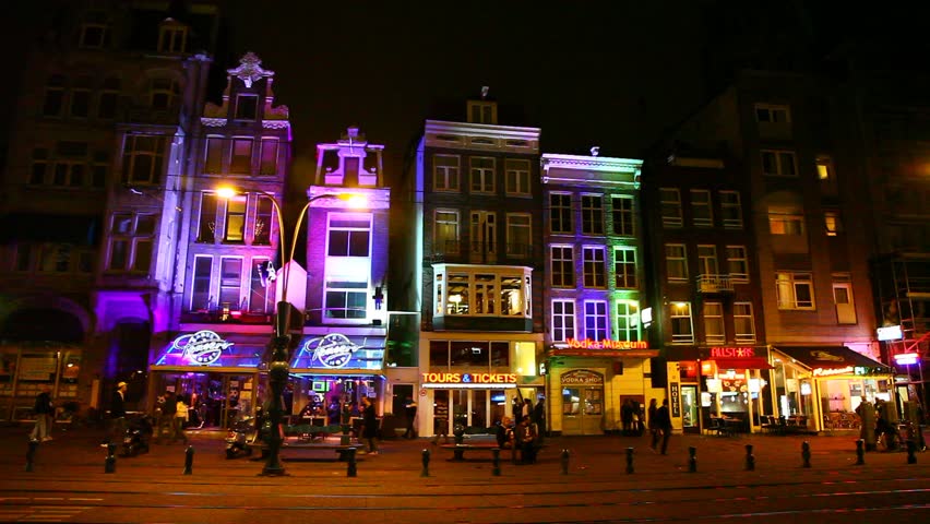 AMSTERDAM, NETHERLANDS - APRIL 16: Tourists visit the red-light district of Amsterdam, April 16, 2011, Amsterdam, Netherlands.
