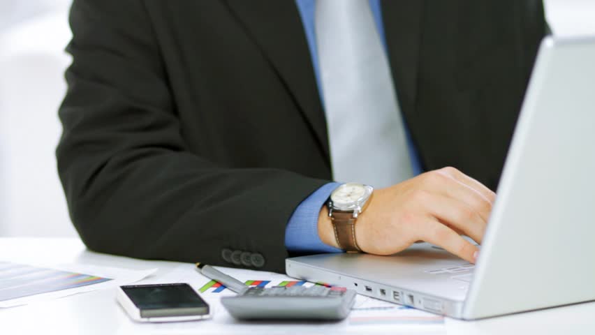 Happy businessman resting in a front of computer