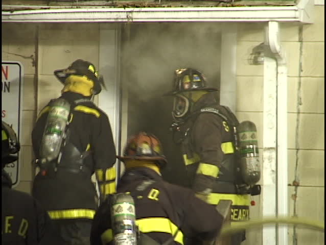 firemen enter burning house