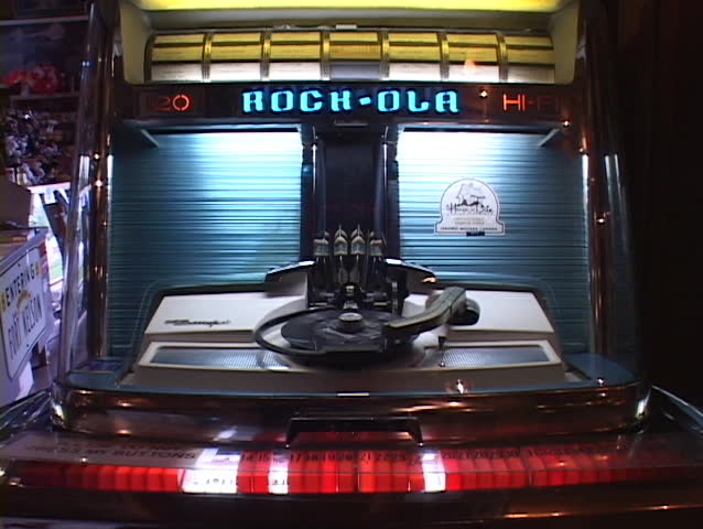 A 45 rpm record is played on an old fashioned jukebox.