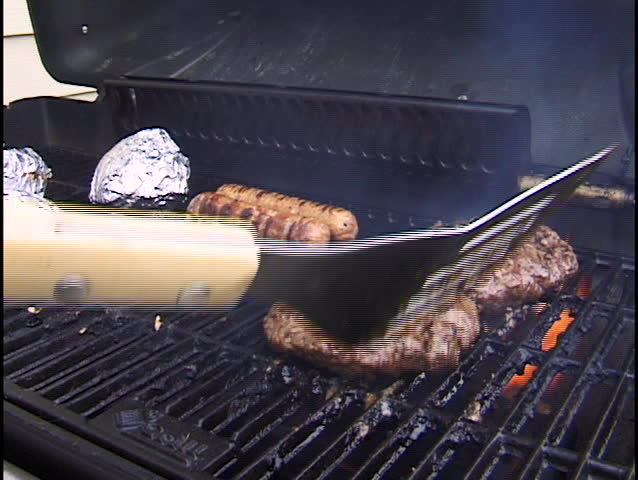 flipping burger on grill