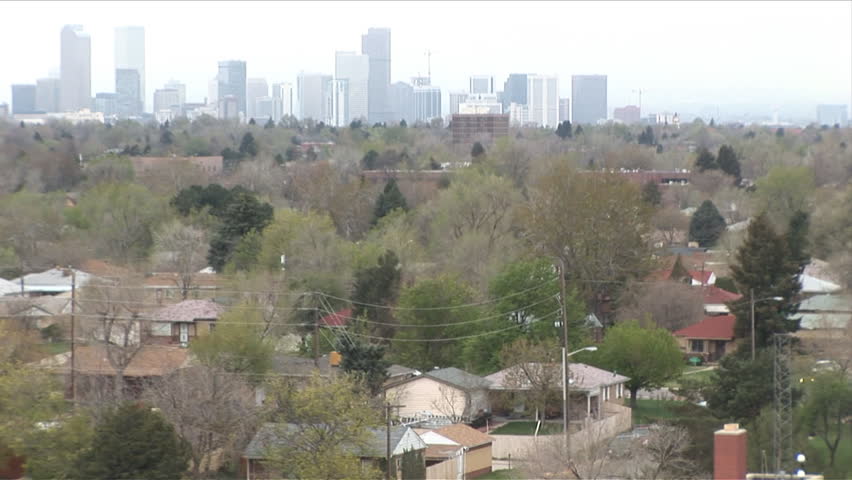 Tilt from Denver suburbs to downtown buildings