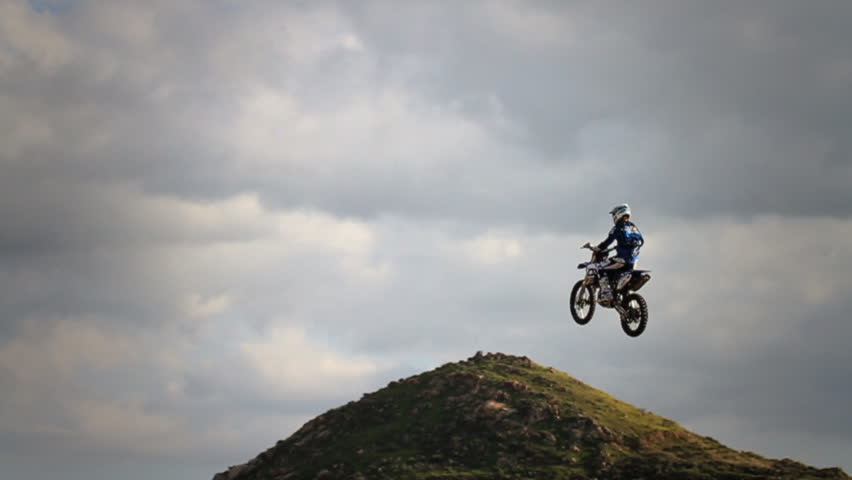 Static shot of blue rider jumping ramp (lean-back)