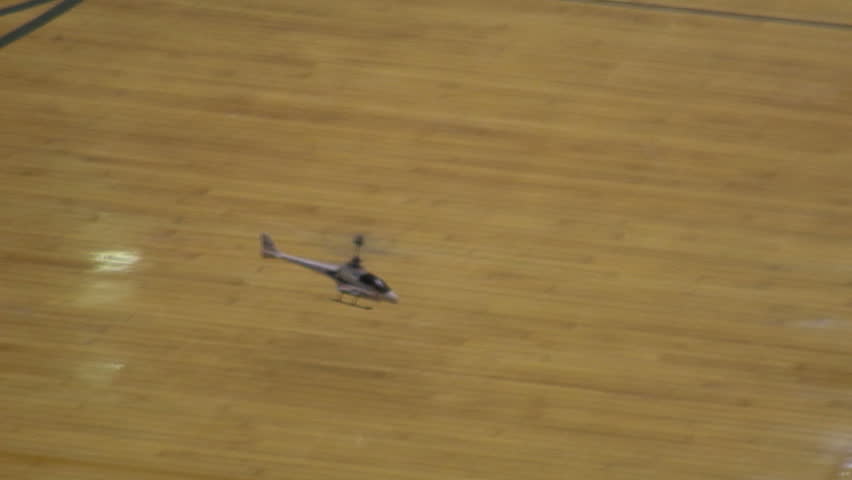 Radio-controlled foam model airplane performing aerobatic tricks at the competition venue