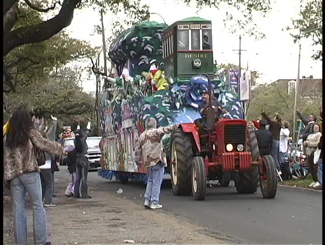 NEW ORLEANS, LA - CIRCA 2010: A Mardi Gras float contains a streetcar called Desire and colorfully dressed characters throwing strands of colored beads to the crowds circa 2010 in New Orleans, LA.