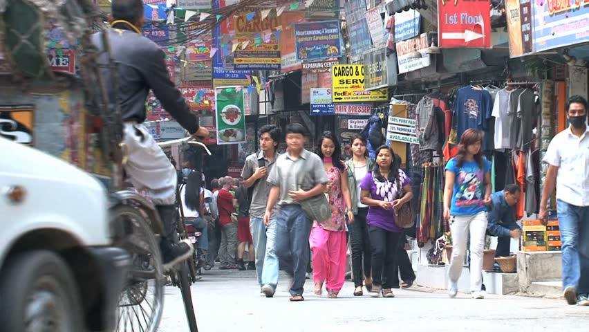 KATHMANDU - CIRCA 2010: People, cars and bikes circulate through the city circa 2010 in Kathmandu.