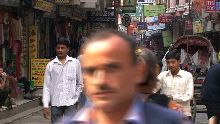 KATHMANDU - CIRCA 2010: People, cars and bikes circulate through the city circa 2010 in Kathmandu.