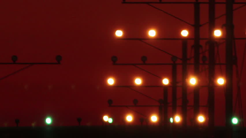 HD footage of a 4 engine jumbo jet plane landing in silhouette against a red sky with visible atmospheric distortion.  Jet engine audio included
