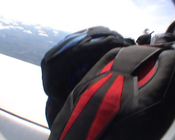 Four skydivers exit airplane