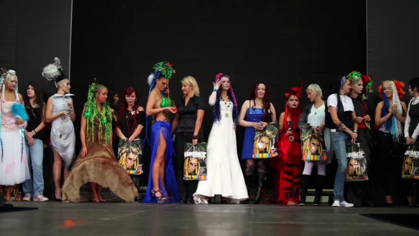 MOSCOW - OCTOBER 2: Several models in costumes stand on stage at dread and afro pigtail competition on III Russian Braiding Contest in exhibition complex Gostiny Dvor, on October 2, 2010 in Moscow.
