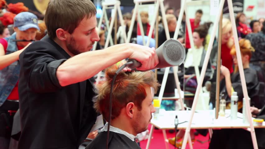 MOSCOW - OCTOBER 2: Hairdresser makes modern hairstyle using spray at XVII International Festival World of Beauty 2010 in exhibition complex Gostiny Dvor, on October 2, 2010 in Moscow, Russia. 
