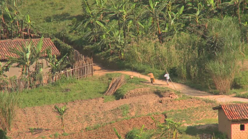 Zoom out from villagers and farmers to reveal the steep and luxurious terrace farms of Rwanda.